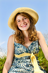 Image showing Young girl sitting in meadow