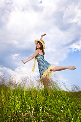 Image showing Young girl dancing in meadow