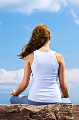 Image showing Young girl meditating outdoors