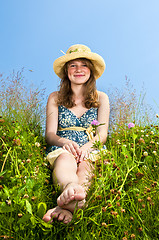 Image showing Young girl sitting in meadow