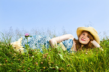 Image showing Young girl laying in meadow