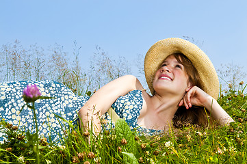 Image showing Young girl laying in meadow