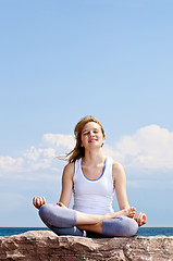 Image showing Young girl meditating outdoors