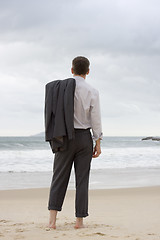 Image showing Businessman relaxing on a beach