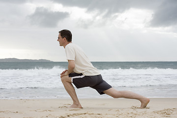 Image showing Man doing fitness exercises on a beach