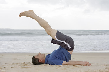 Image showing Man doing fitness exercises on a beach