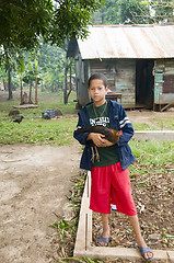 Image showing editorial happy boy with pet hen chicken corn island nicaragua