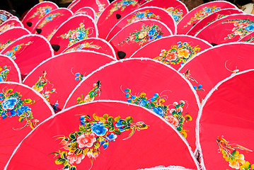 Image showing Hand painted pink umbrellas in Thailand