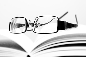 Image showing Eyeglasses on open book