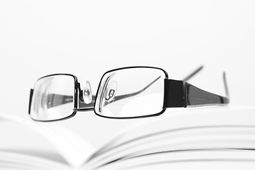 Image showing Eyeglasses on open book
