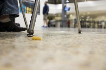 Image showing Floor view with a dropped snack at an airport