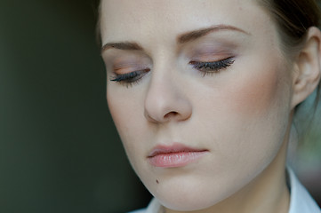 Image showing Woman applying makeup