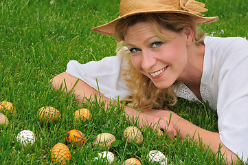 Image showing Young woman and easter eggs on the grass - Easter time