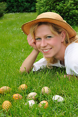 Image showing Young woman and easter eggs on the grass - Easter time