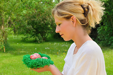 Image showing Young woman and easter eggs