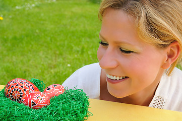 Image showing Young woman and easter eggs