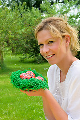 Image showing Young woman and easter eggs