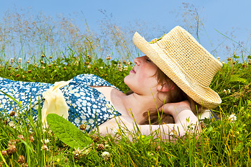 Image showing Young girl resting in meadow
