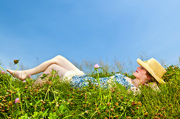 Image showing Young girl laying in meadow