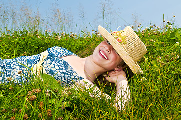 Image showing Young girl laying on meadow