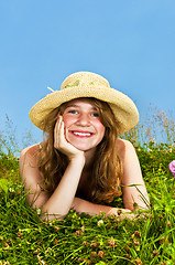 Image showing Young girl laying in meadow