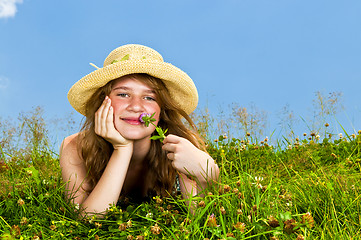 Image showing Young girl laying in meadow