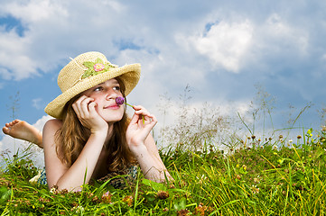 Image showing Young girl laying in meadow