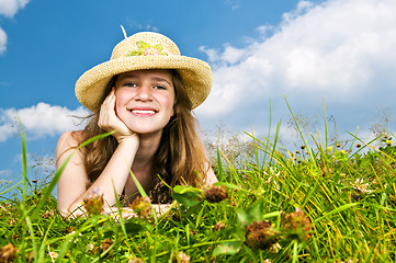 Image showing Young girl laying in meadow