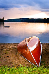 Image showing Lake sunset with canoe on beach