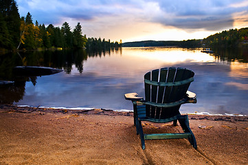 Image showing Wooden chair at sunset on beach