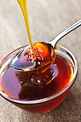 Image showing Honey dripping onto spoon