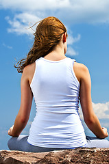 Image showing Young girl meditating outdoors