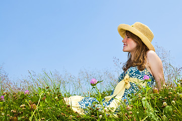 Image showing Young girl sitting in meadow