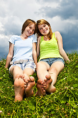 Image showing Young girls sitting in meadow