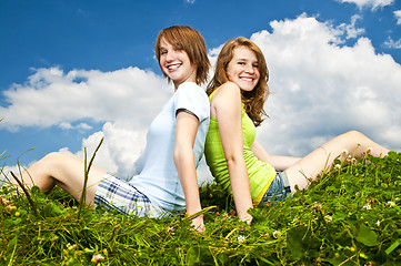 Image showing Young girls sitting in meadow