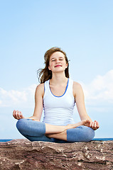Image showing Young girl meditating outdoors