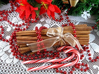 Image showing Christmas candy canes, cinnamon sticks and poinsettias