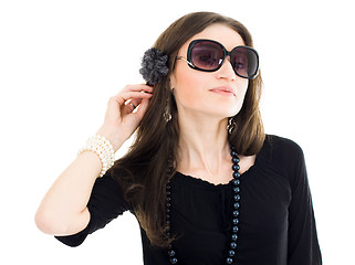 Image showing Woman in black dress and sunglasses listen