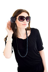 Image showing Woman in black dress and sunglasses listen