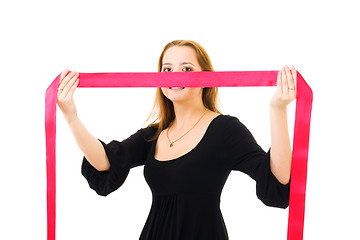 Image showing romantic woman hiding behind red ribbon