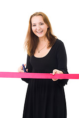 Image showing Woman cutting a red ribbon