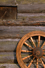 Image showing Spinning Wheel On The Log Hut Wall