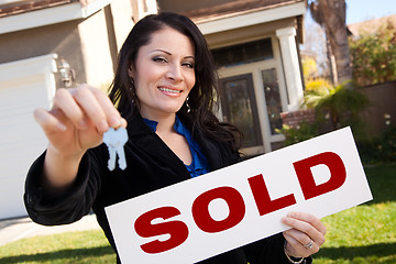 Image showing Hispanic Woman Holding Keys and Sold Sign In Front of House