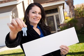 Image showing Attractive Hispanic Woman Holding Blank Sign in Front of House
