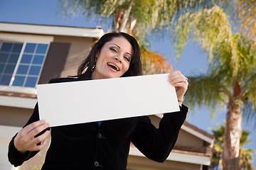 Image showing Attractive Hispanic Woman Holding Blank Sign in Front of House