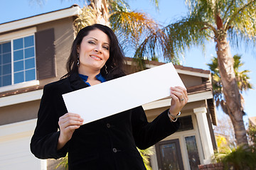 Image showing Attractive Hispanic Woman Holding Blank Sign in Front of House