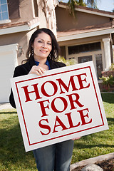Image showing Woman Holding Home For Sale Real Estate Sign In Front of House