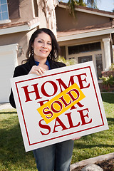 Image showing Woman Holding Sold Real Estate Sign In Front of House