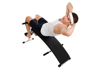 Image showing Young man exercise on bench working on abdominal muscles