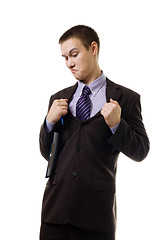 Image showing Young man in formal suit tear it apart because of wrong size